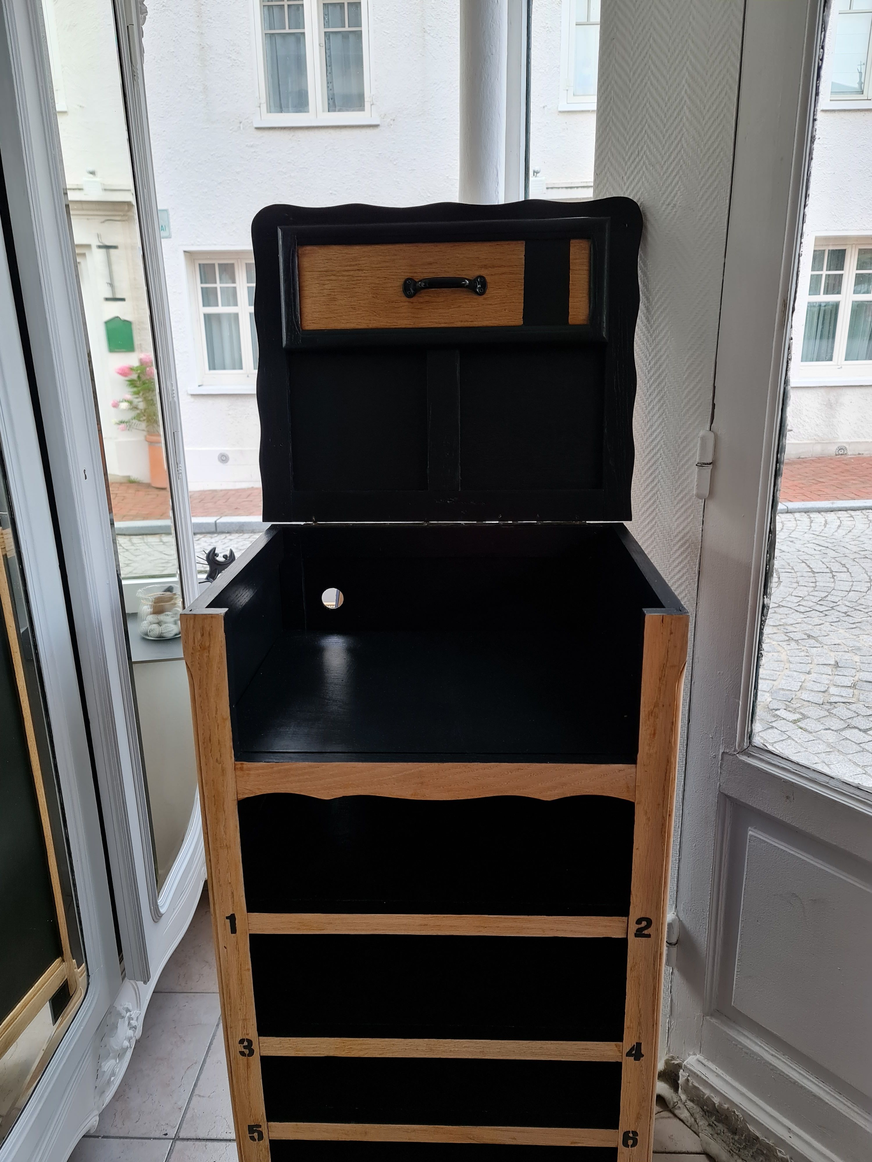 Raw oak and matte black storage cabinet on stencil top and transfer