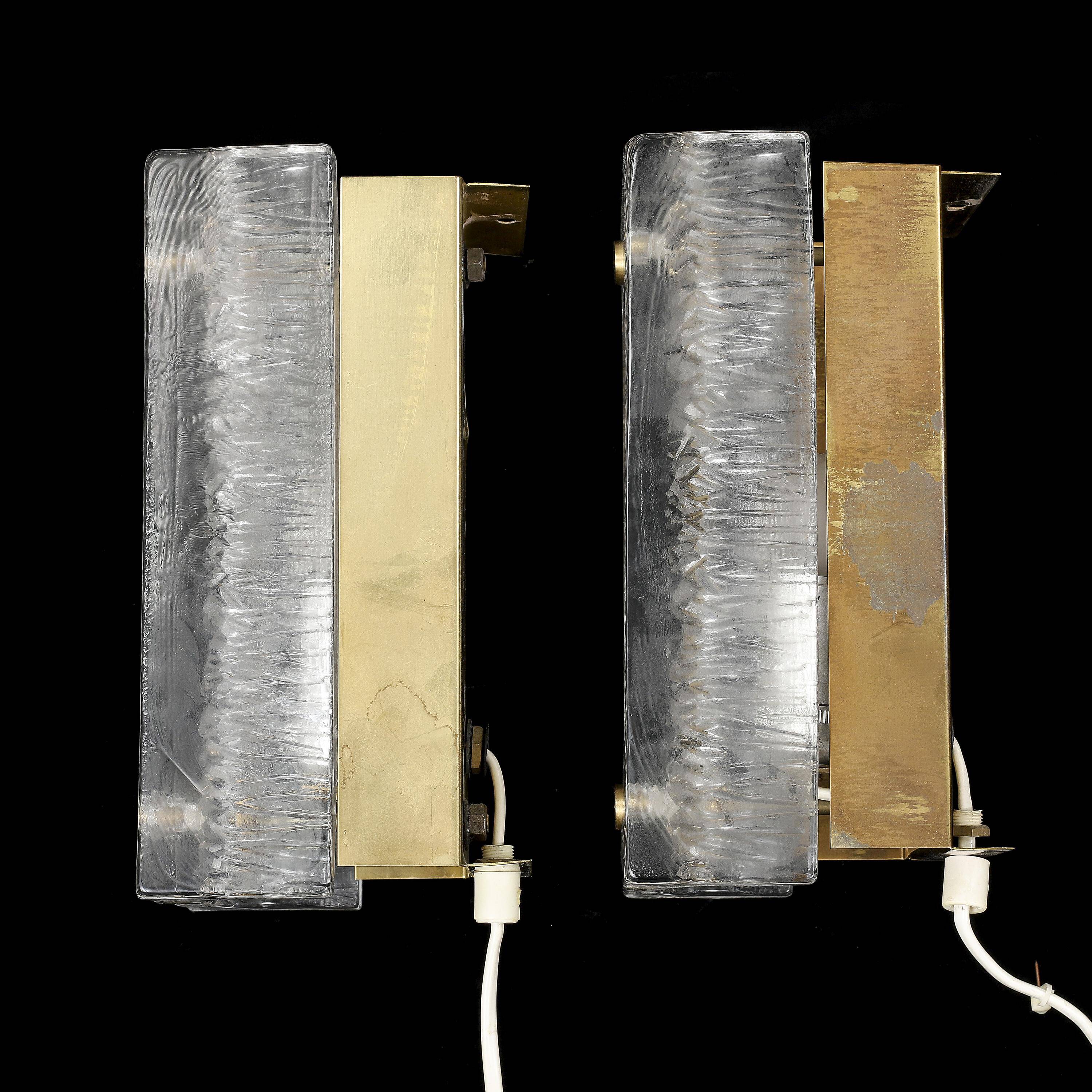 Pair of Orrefors wall lights in cast glass and brass, Sweden 1960.