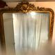 Large antique mirror with flagship shell in wood and gilded stucco