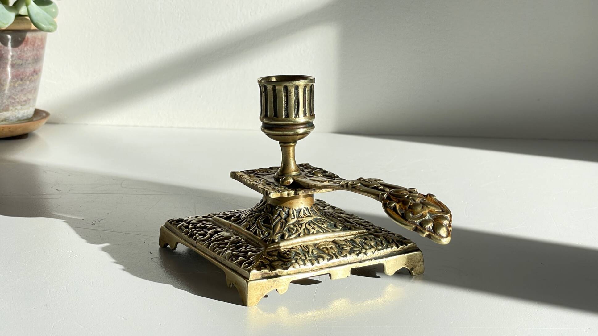 Patterned solid bronze hand candle holder