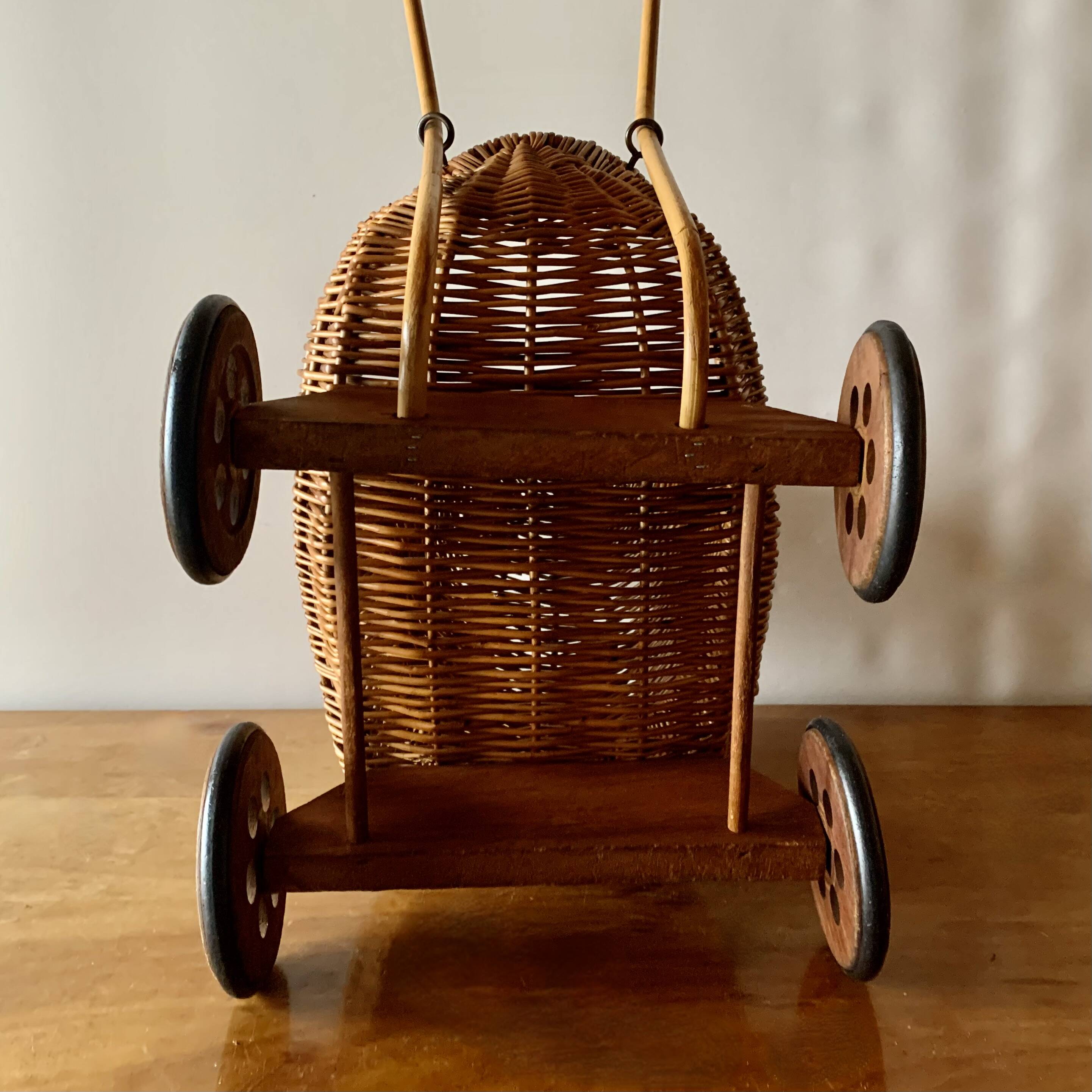 Old wicker dolls' pram - wooden wheels