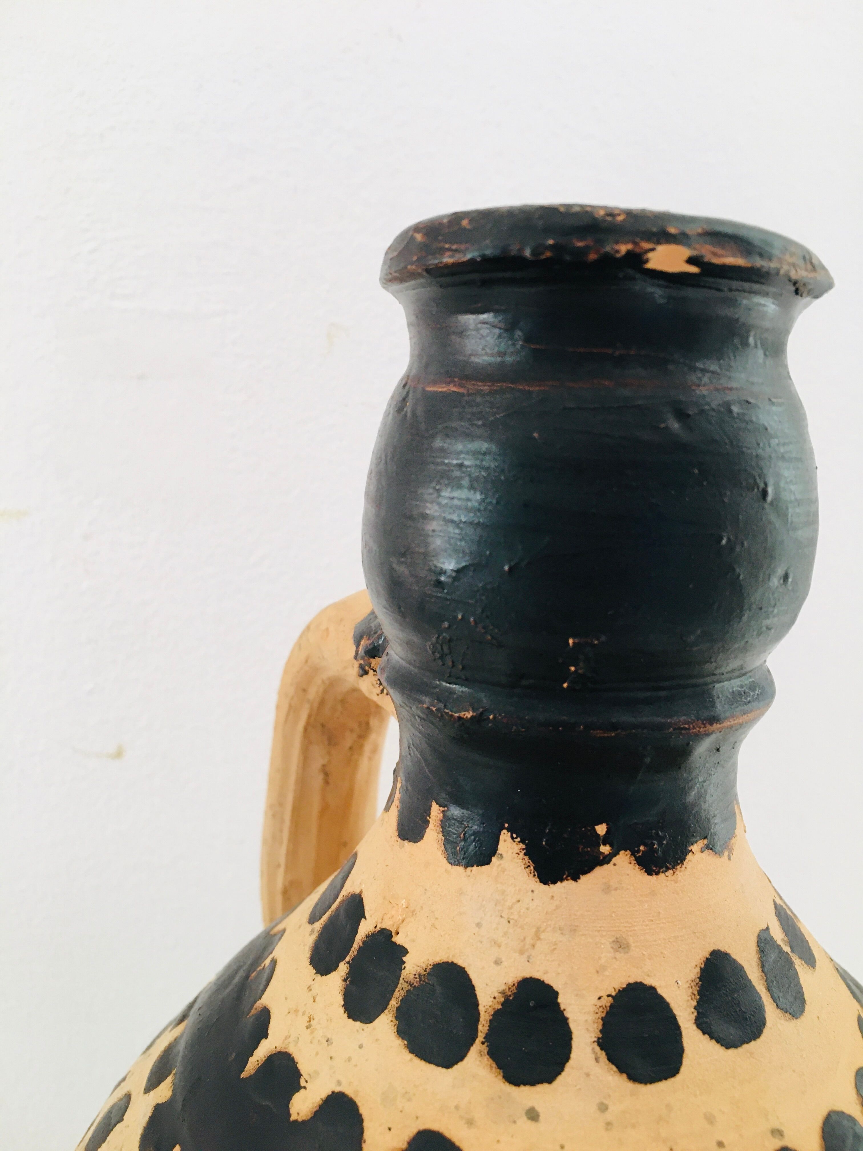 Raw and black terracotta jug