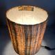 Small modernist table lamp with hand-woven shade.