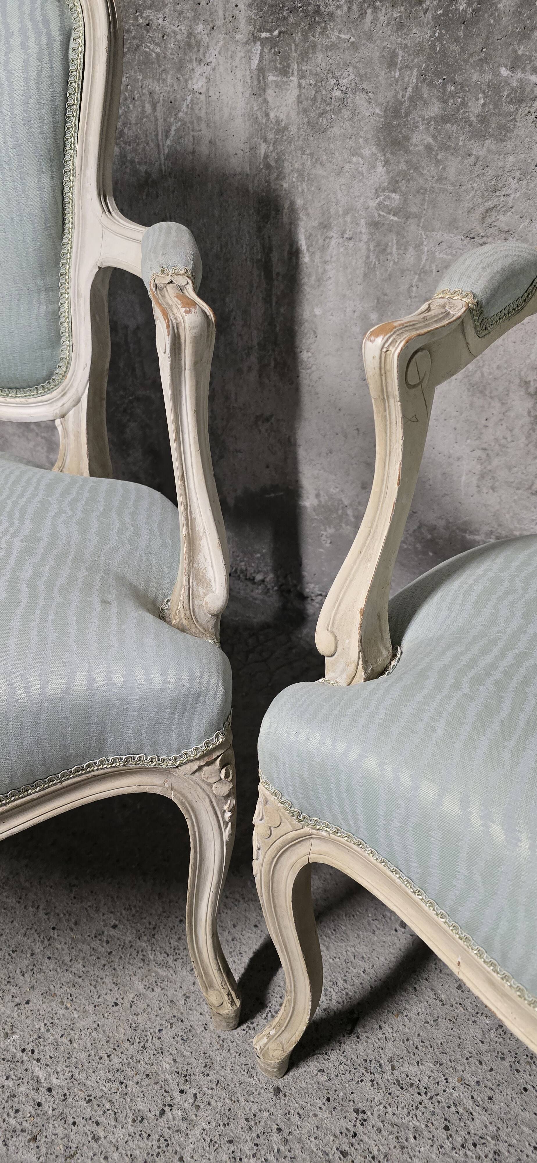 Pair of Louis XV style armchairs in patinated wood, light blue fabric.