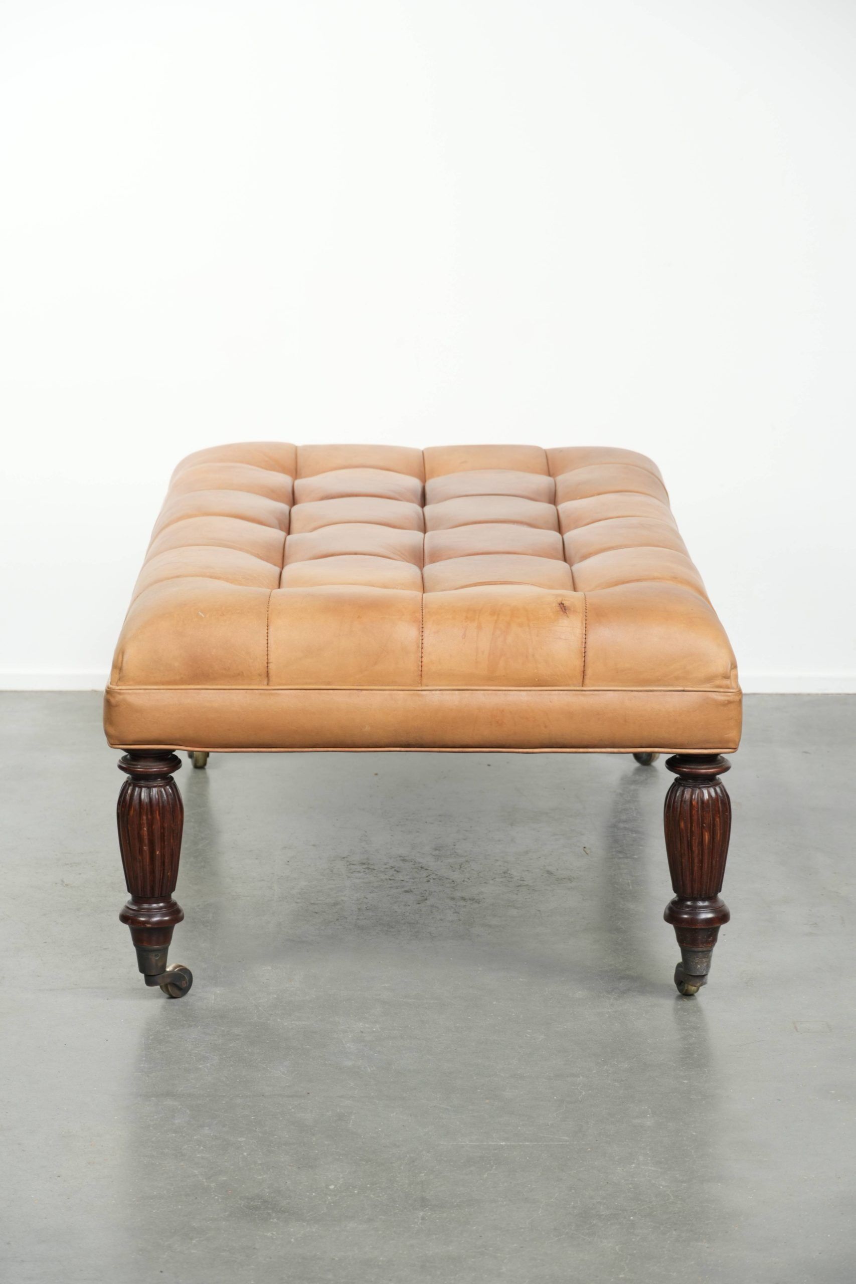 Sheepskin ottoman/coffee table on wheels in English chesterfield style