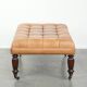Sheepskin ottoman/coffee table on wheels in English chesterfield style