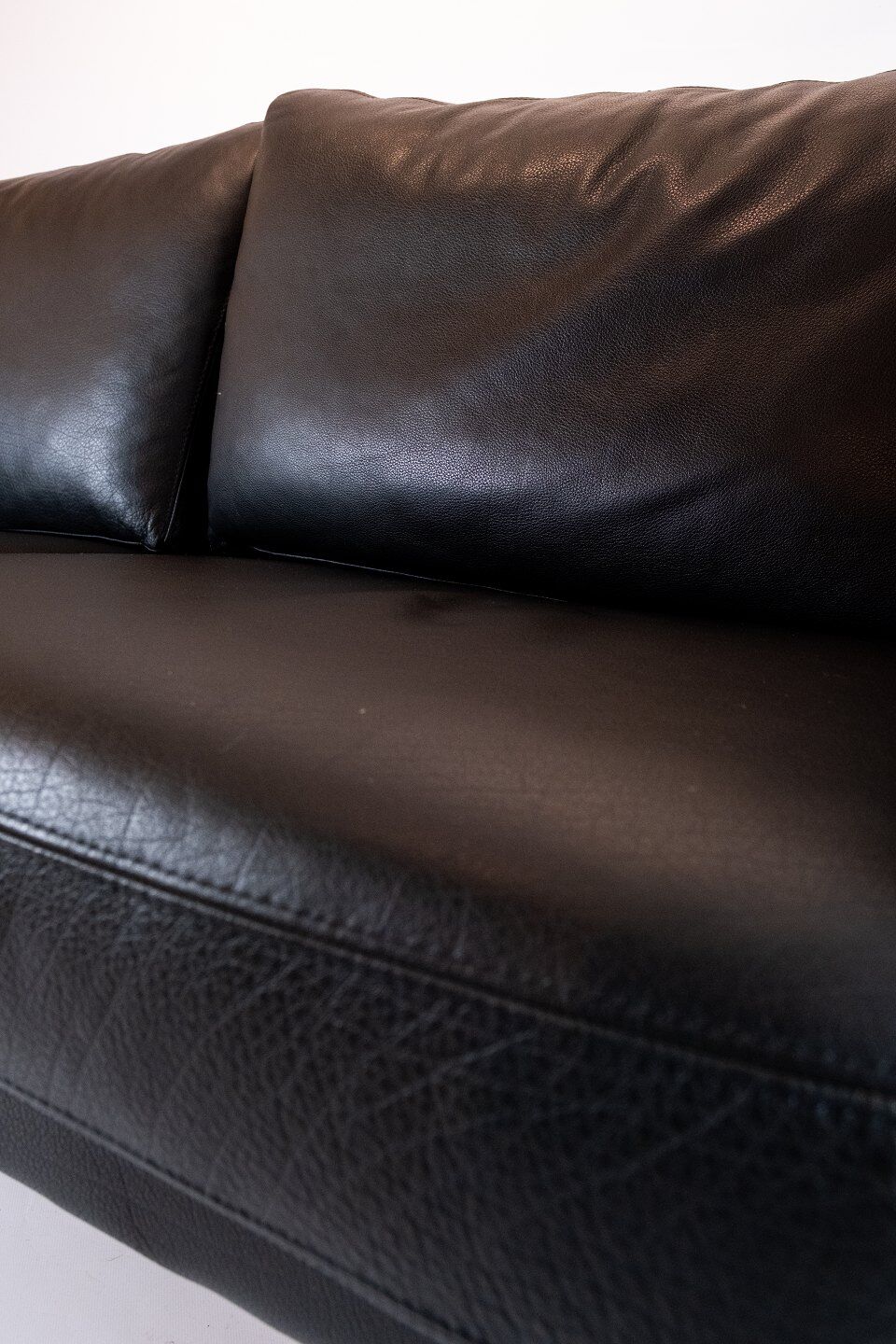Two seater sofa upholstered with black leather and of danish design