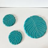 Ceramic trivet and bottle coaster from the 1950s.