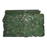 Green enamelled ceramic stove tile — finely sculpted Hungarian pattern from the late 19th century.