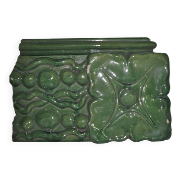 Green enamelled ceramic stove tile — finely sculpted Hungarian pattern from the late 19th century.