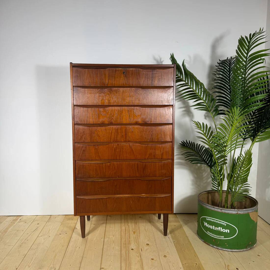 Mid-century Danish high chest of drawers with eight teak drawers.