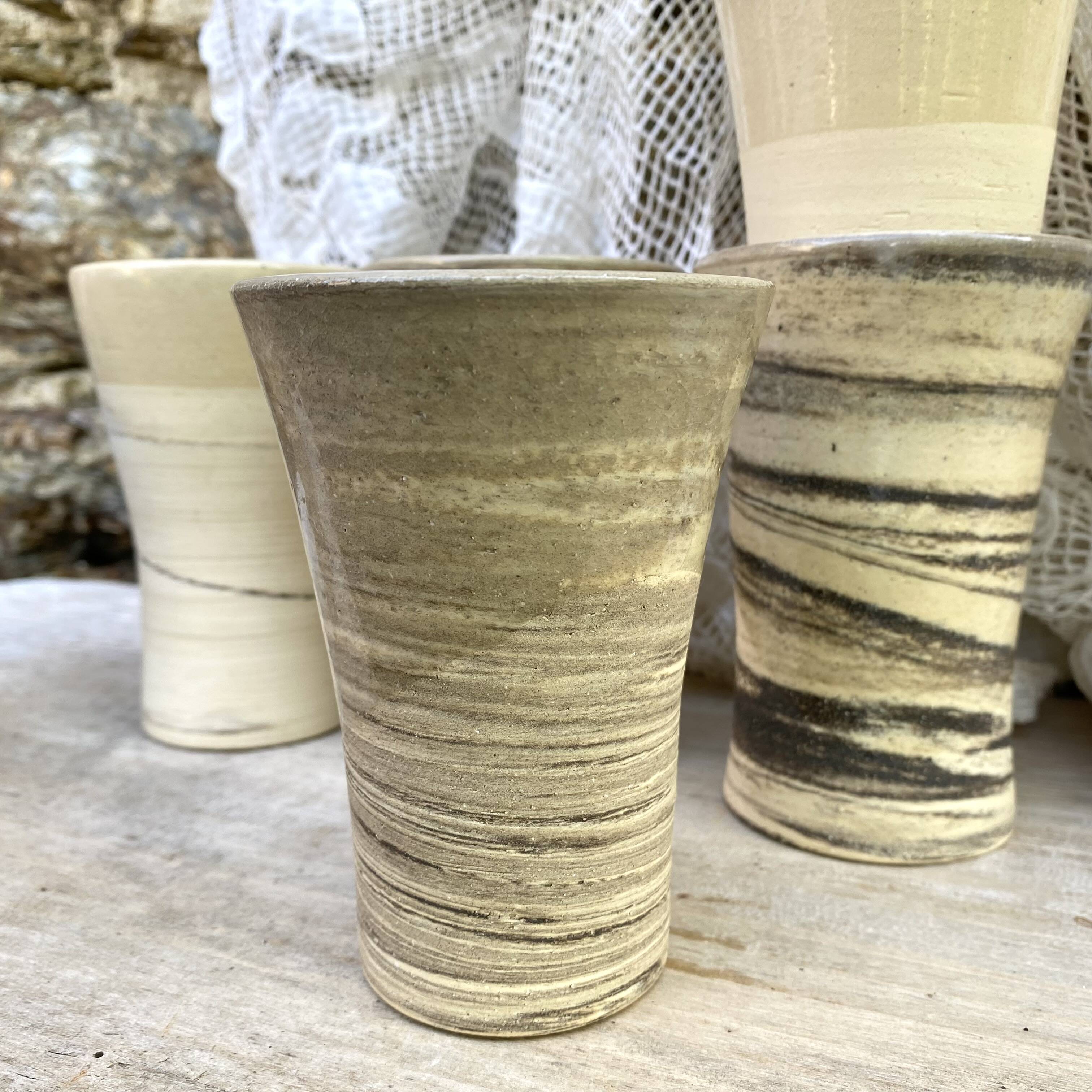 High ceramic cups made of mixed clay.