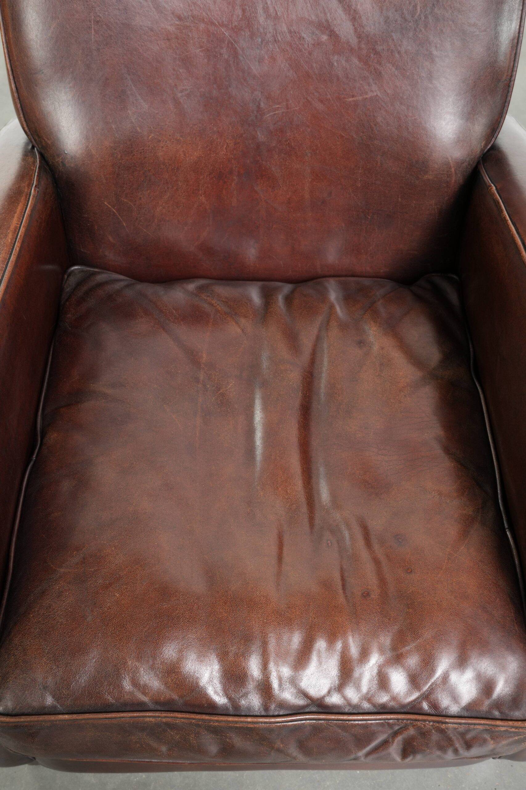 Dark cognac-coloured set of 2 sheepskin armchairs with a sleek design