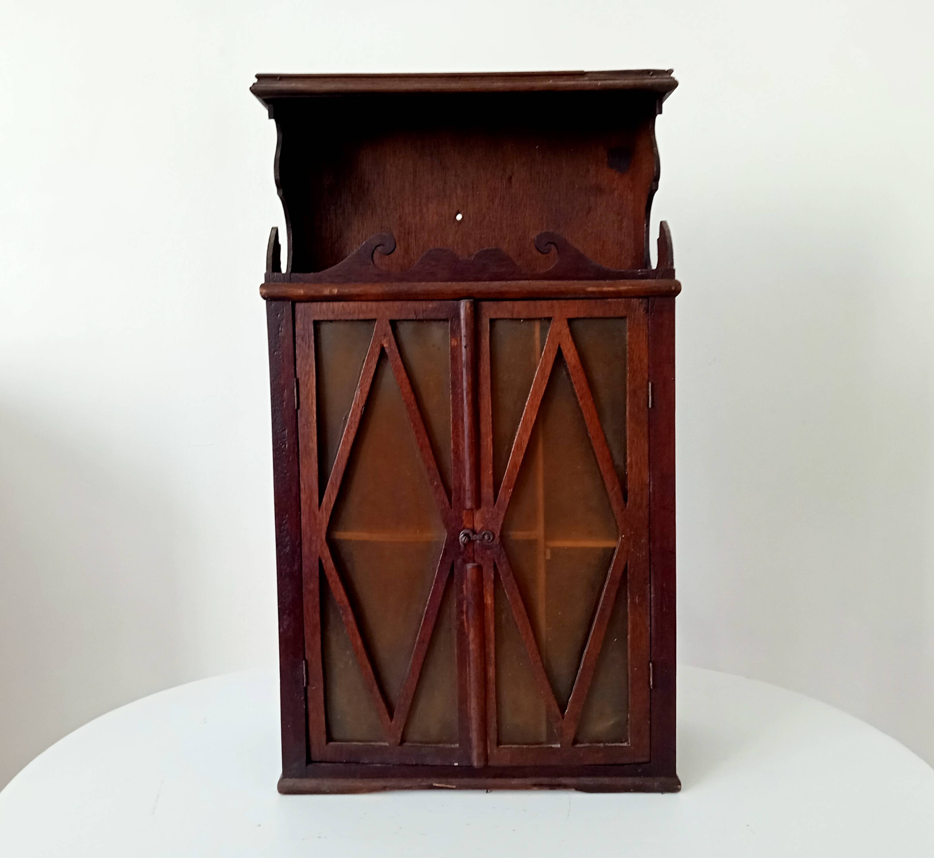Small antique wall cabinet in Gothic style.
