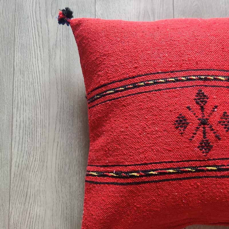 Red Berber cushion with cotton pompom