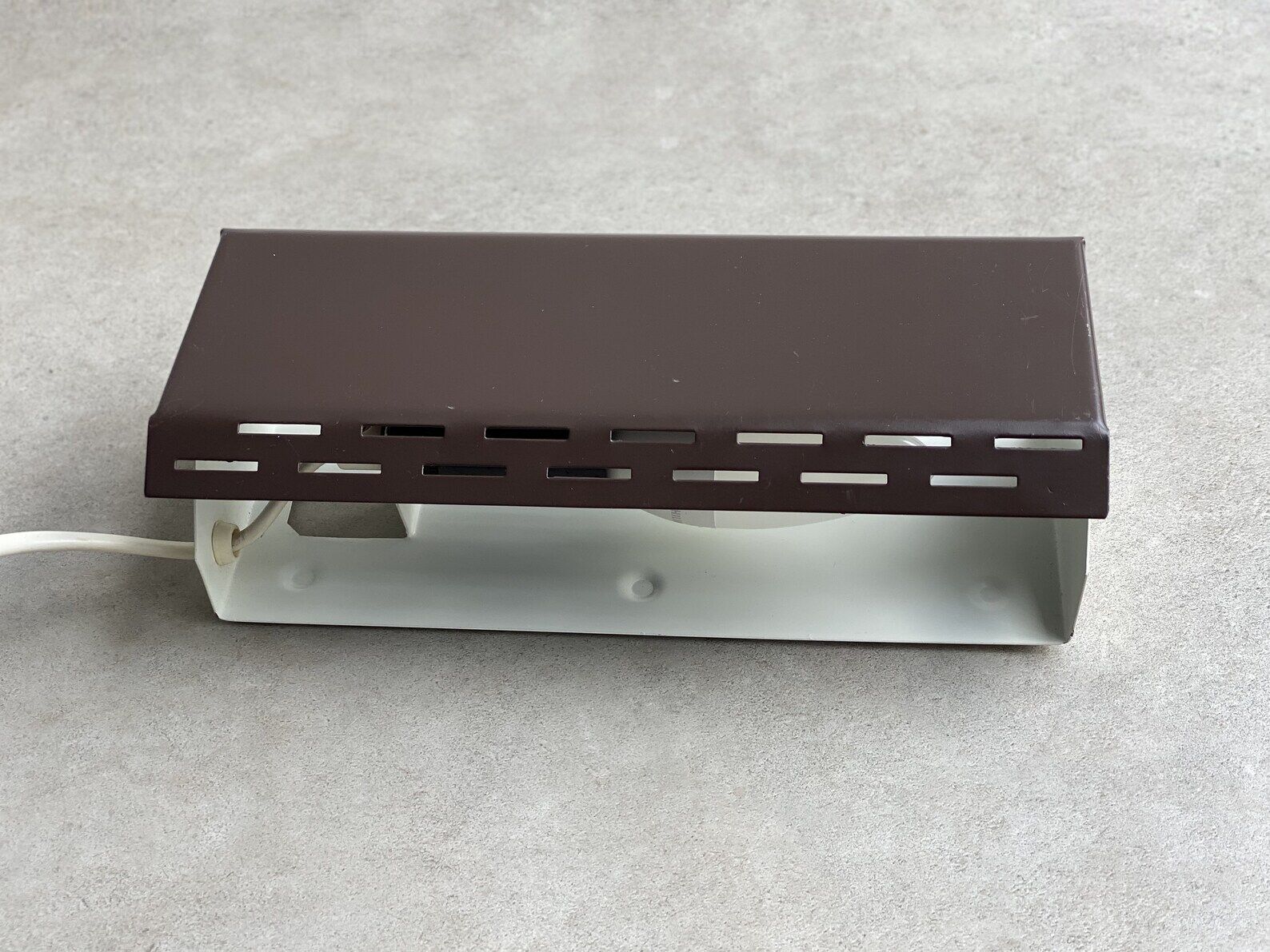 Wall sconce with a perforated shade