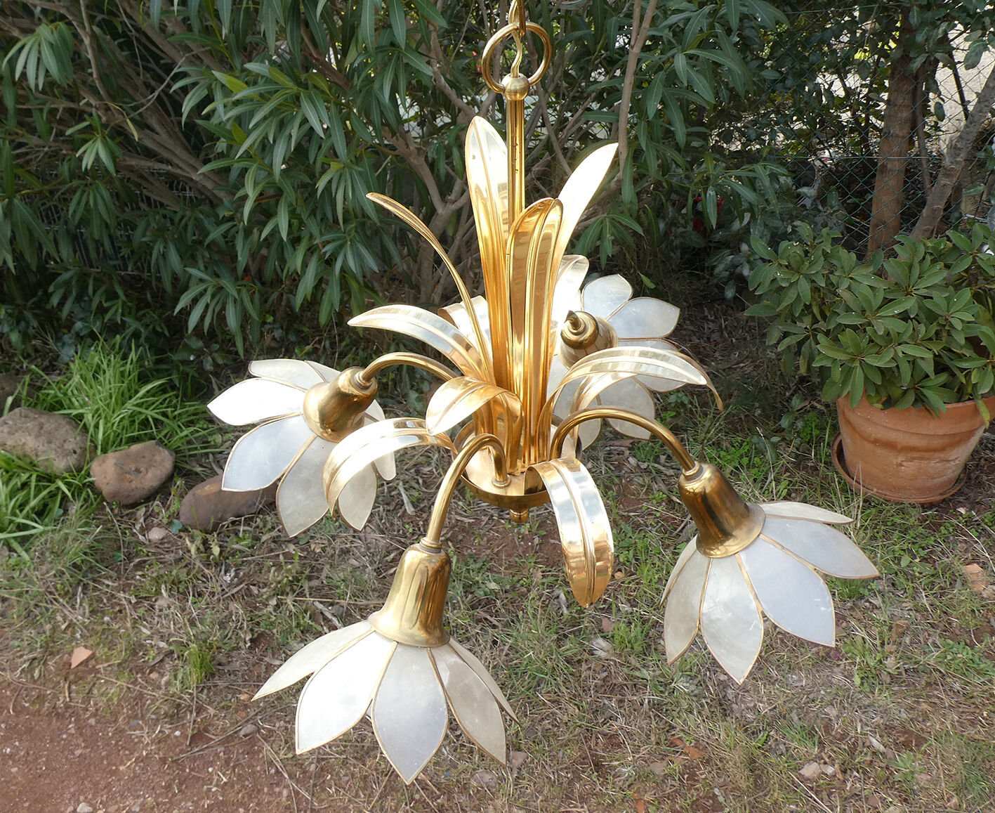 Brass chandelier and flowers in mother-of-pearl petals