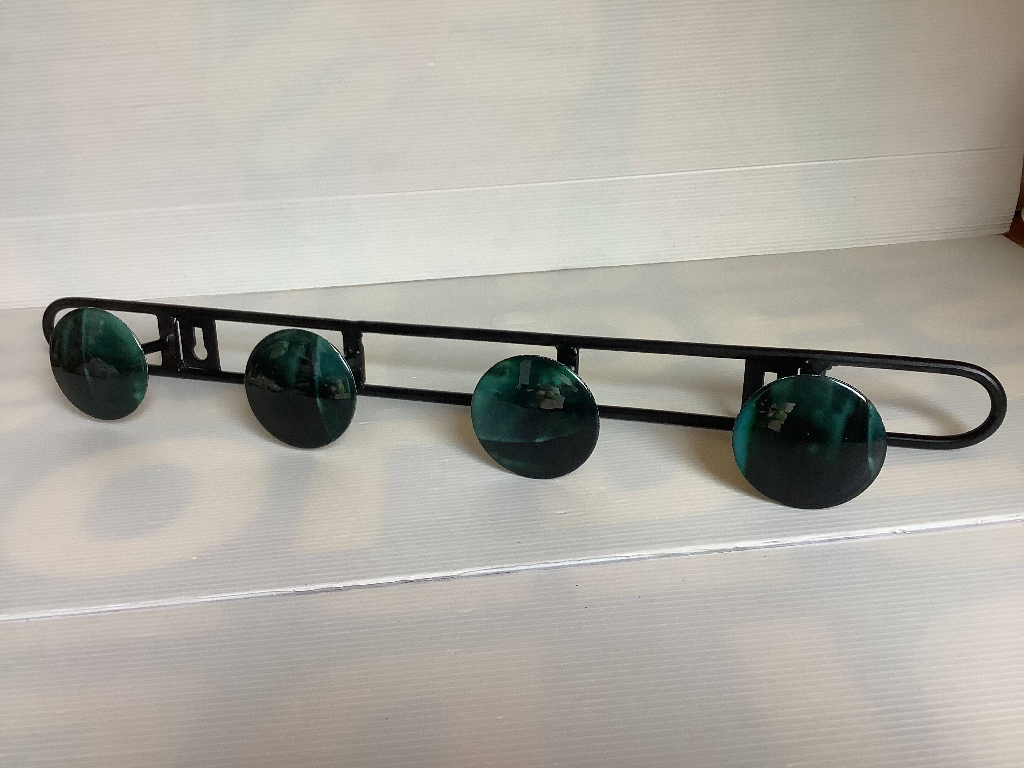 Green black metal coat rack with four hooks