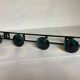 Green black metal coat rack with four hooks