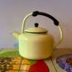 Old kettle in yellow enamelled sheet metal and Bakelite