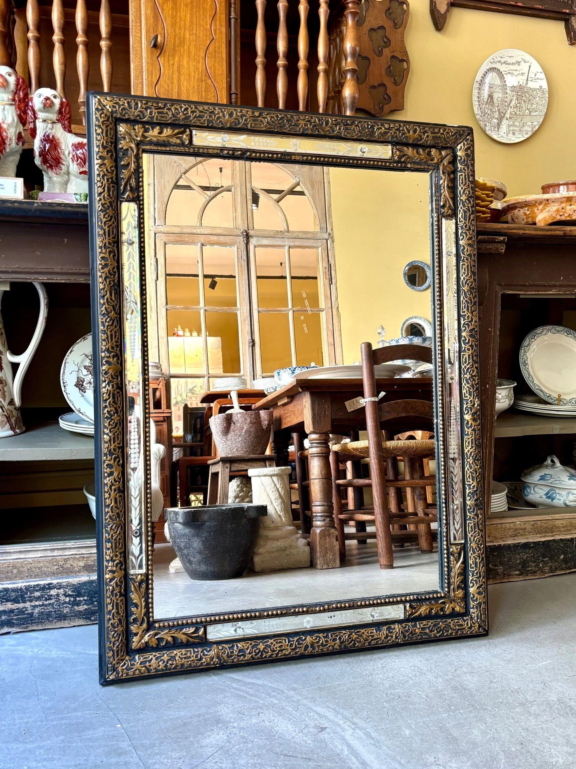 Rectangular Napoleon III mirror in moulded black and gold wood with engraved mirror decoration.