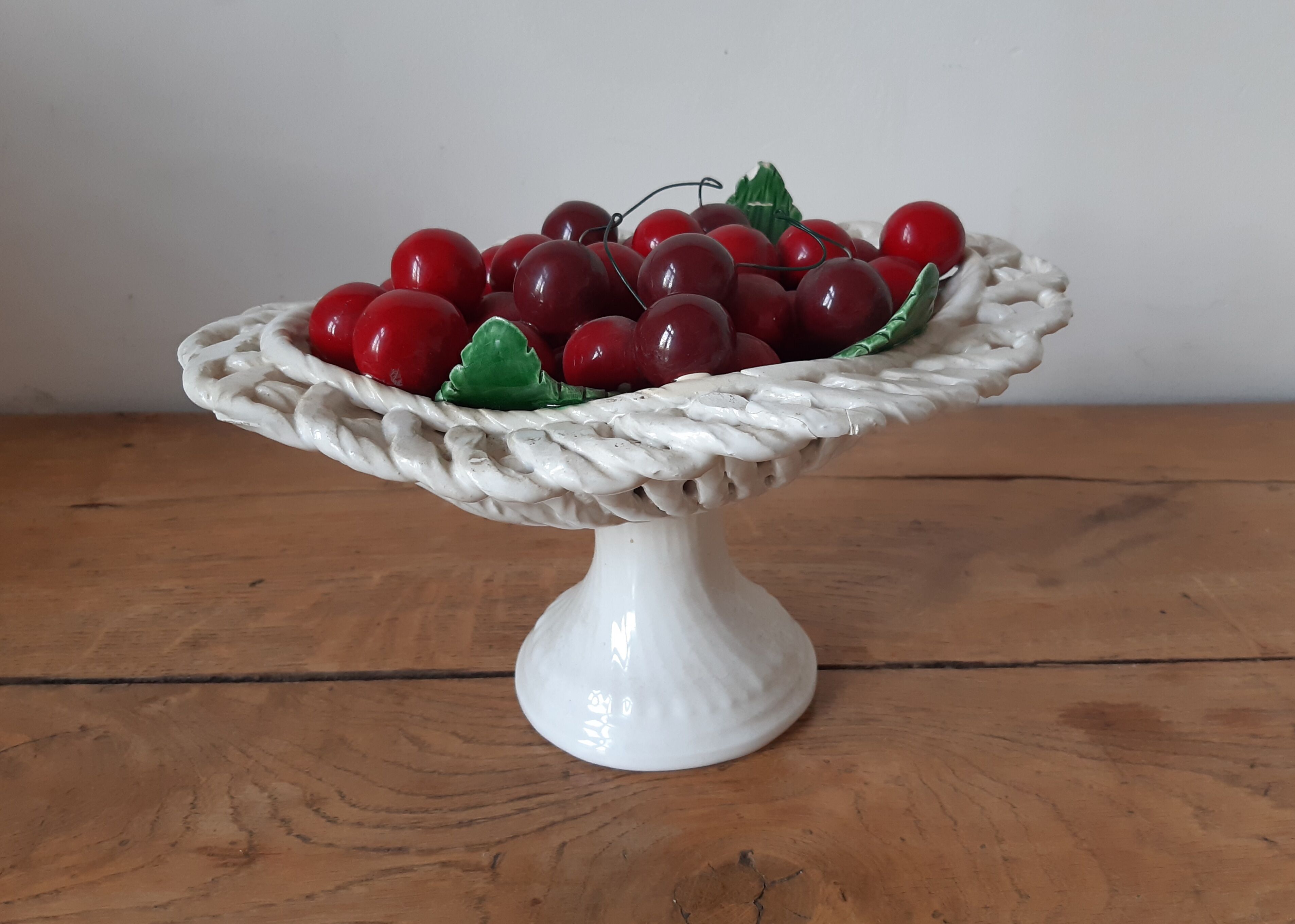 Braided basket of porcelain cherries, Bassano vintage 60s