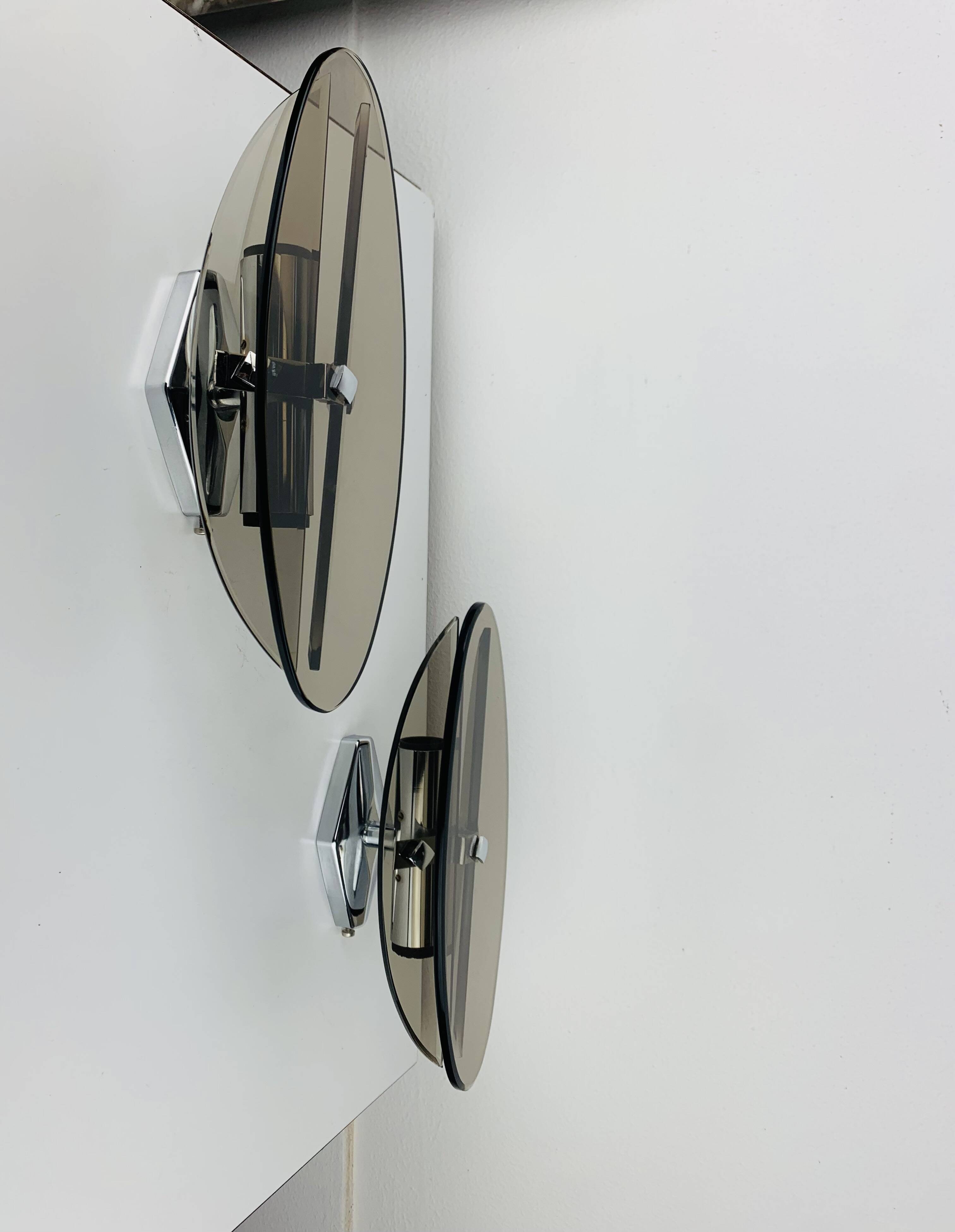 Pair of smoked glass and chrome wall lights from the 1970s.
