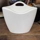 Design magazine rack in milky white by Elie Jacobson