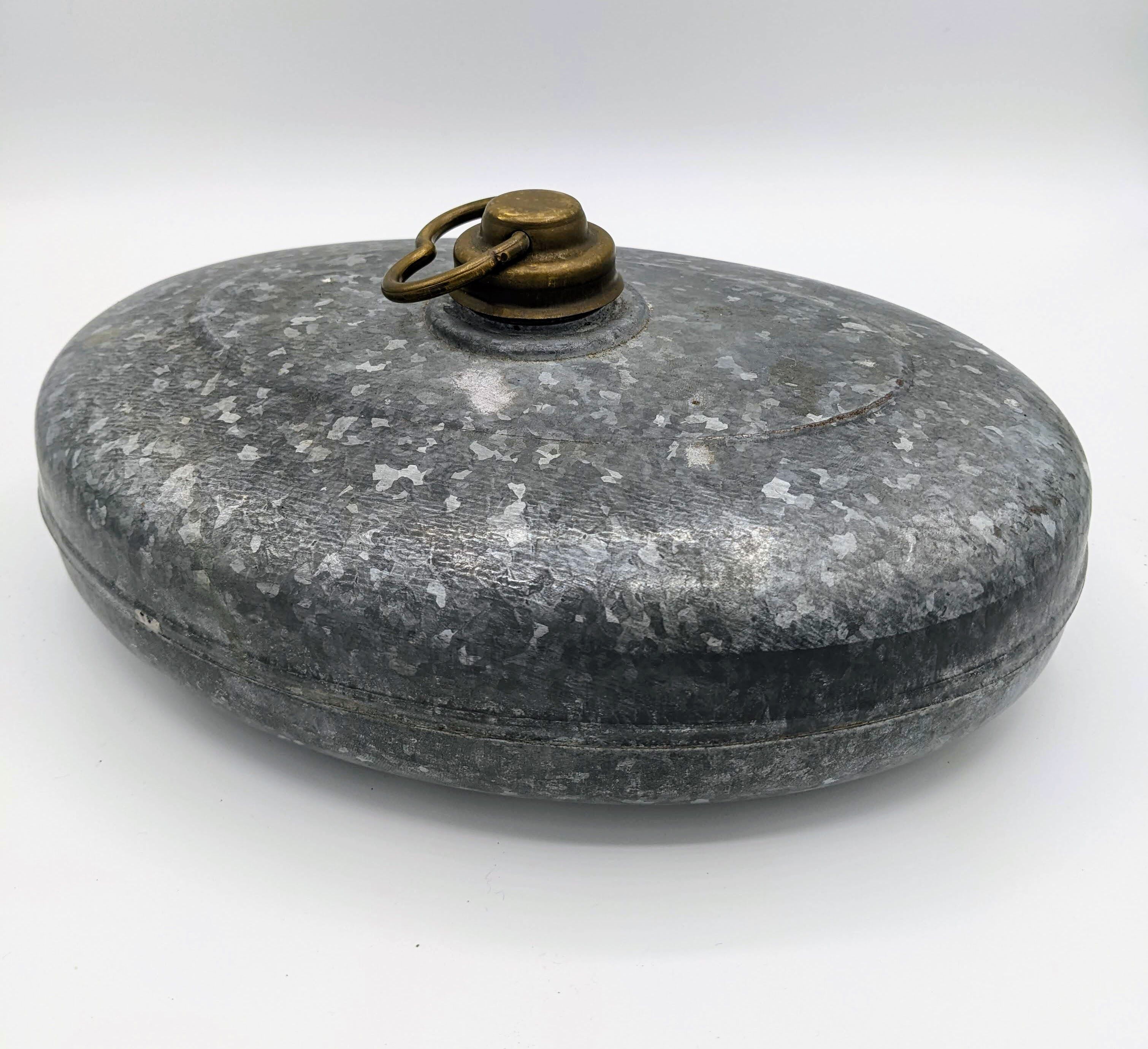 Old metal hot water bottle