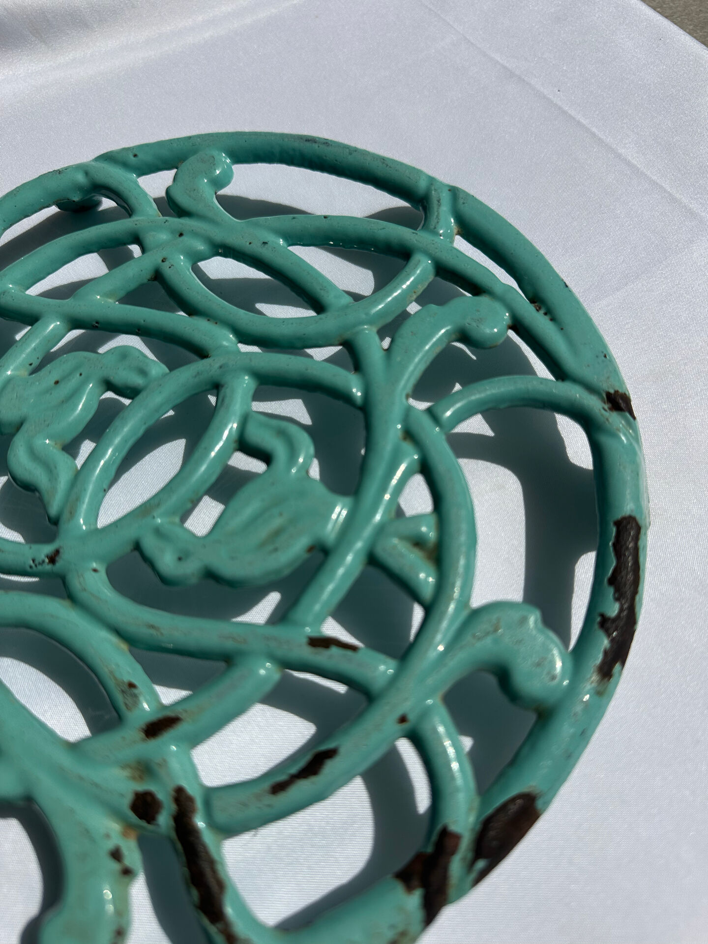 Enamelled cast iron trivet in blue with wrought iron decoration.