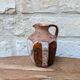 Old small pitcher in glazed terracotta