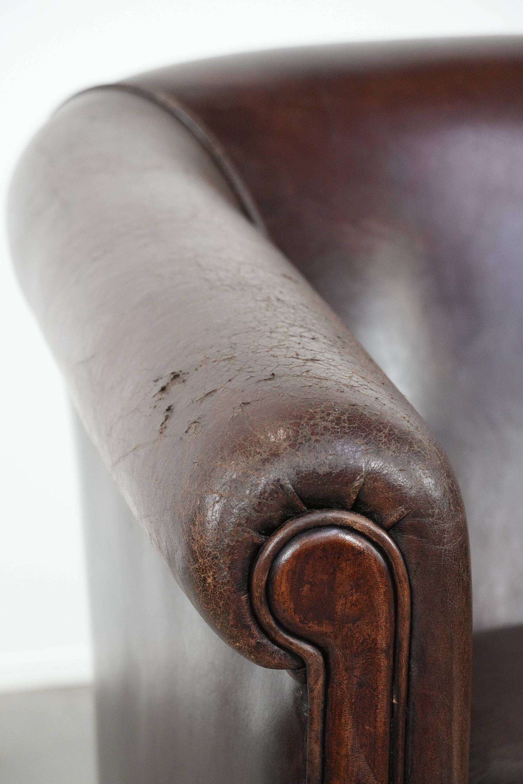 Stylish and sturdy dark brown club armchair made of sheepskin leather