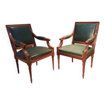 Pair of Louis XVI style armchairs upholstered in green leather.