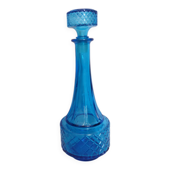 Turquoise glass carafe bottle with a stopper.