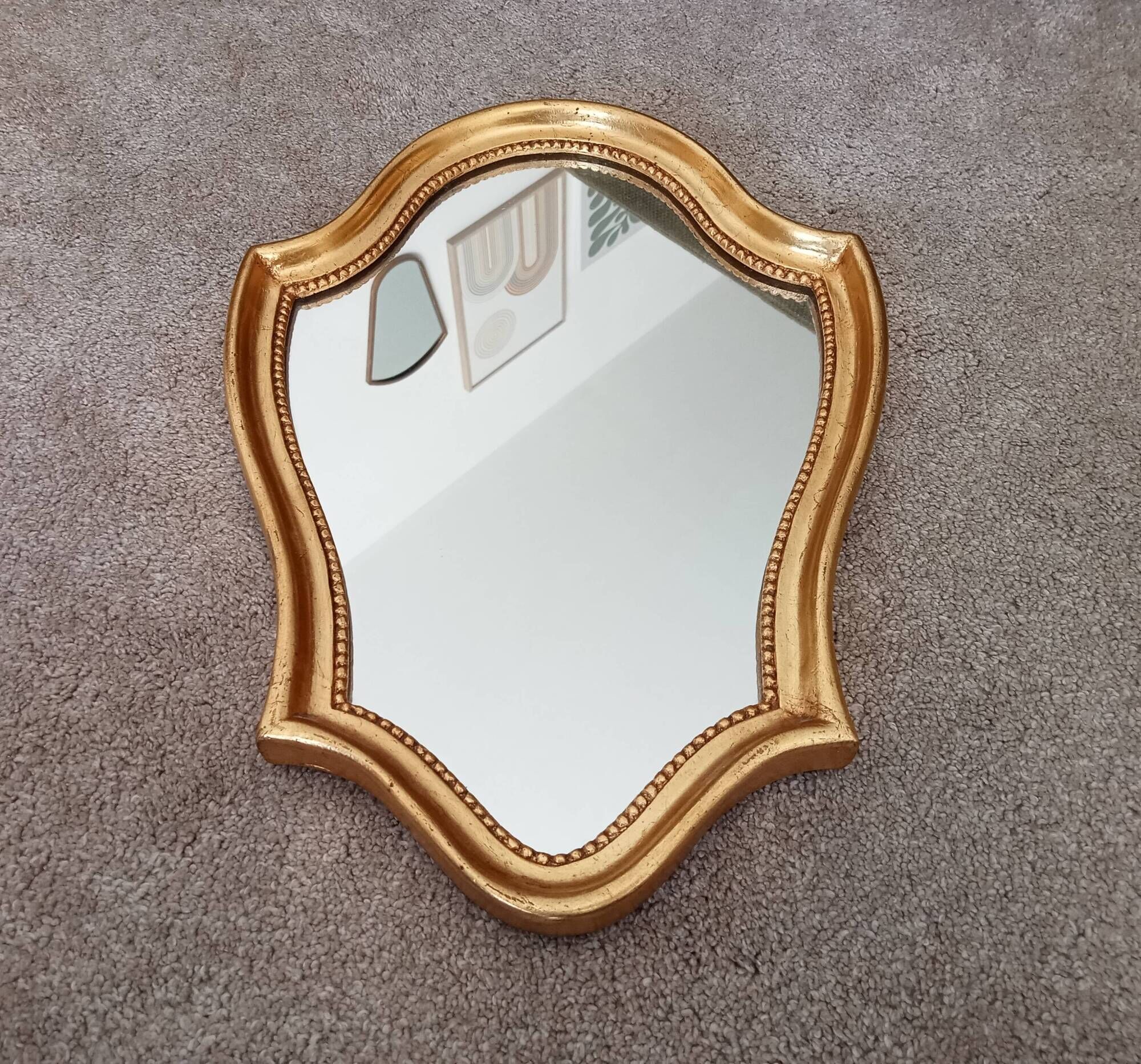 Vintage baroque mirror in gilded wood in the Louis XV style.