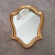 Vintage baroque mirror in gilded wood in the Louis XV style.