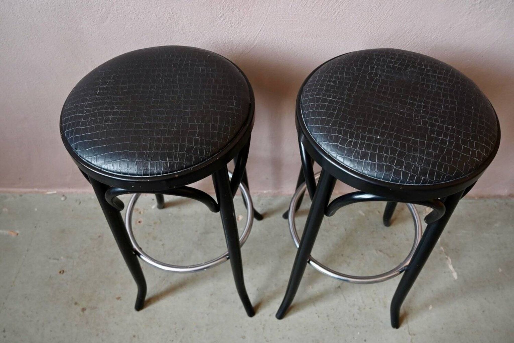 Pair of 1960s bistro bar stools in black and chrome with vinyl shell.