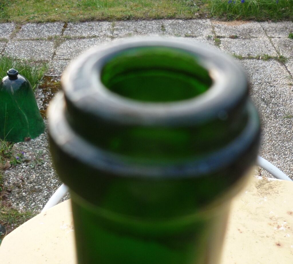 Green blown glass bottle of 58 cm.