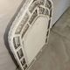 Vintage white rattan mirror with a gothic frame.