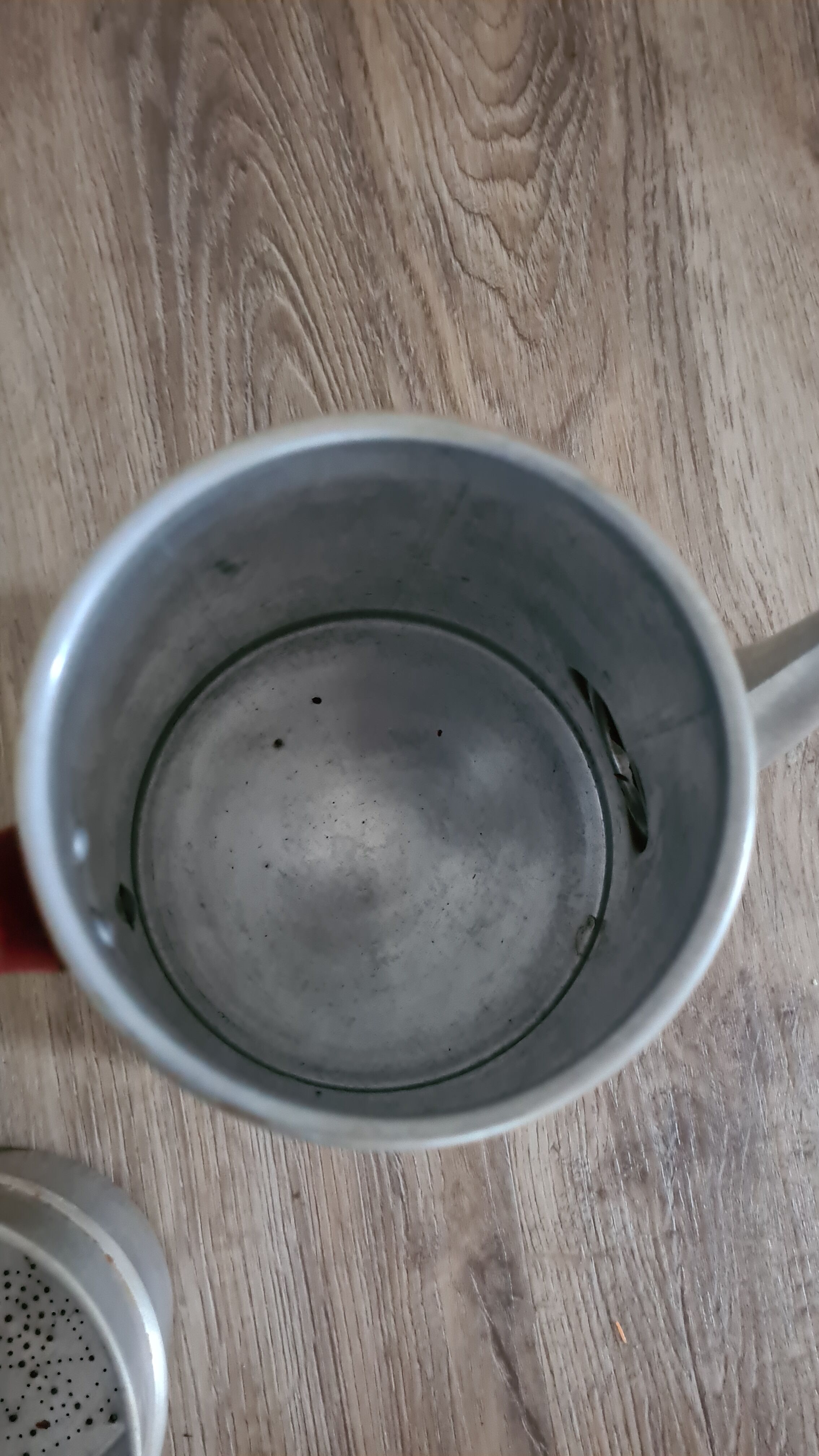 Old enamelled coffee maker in red handle aluminum