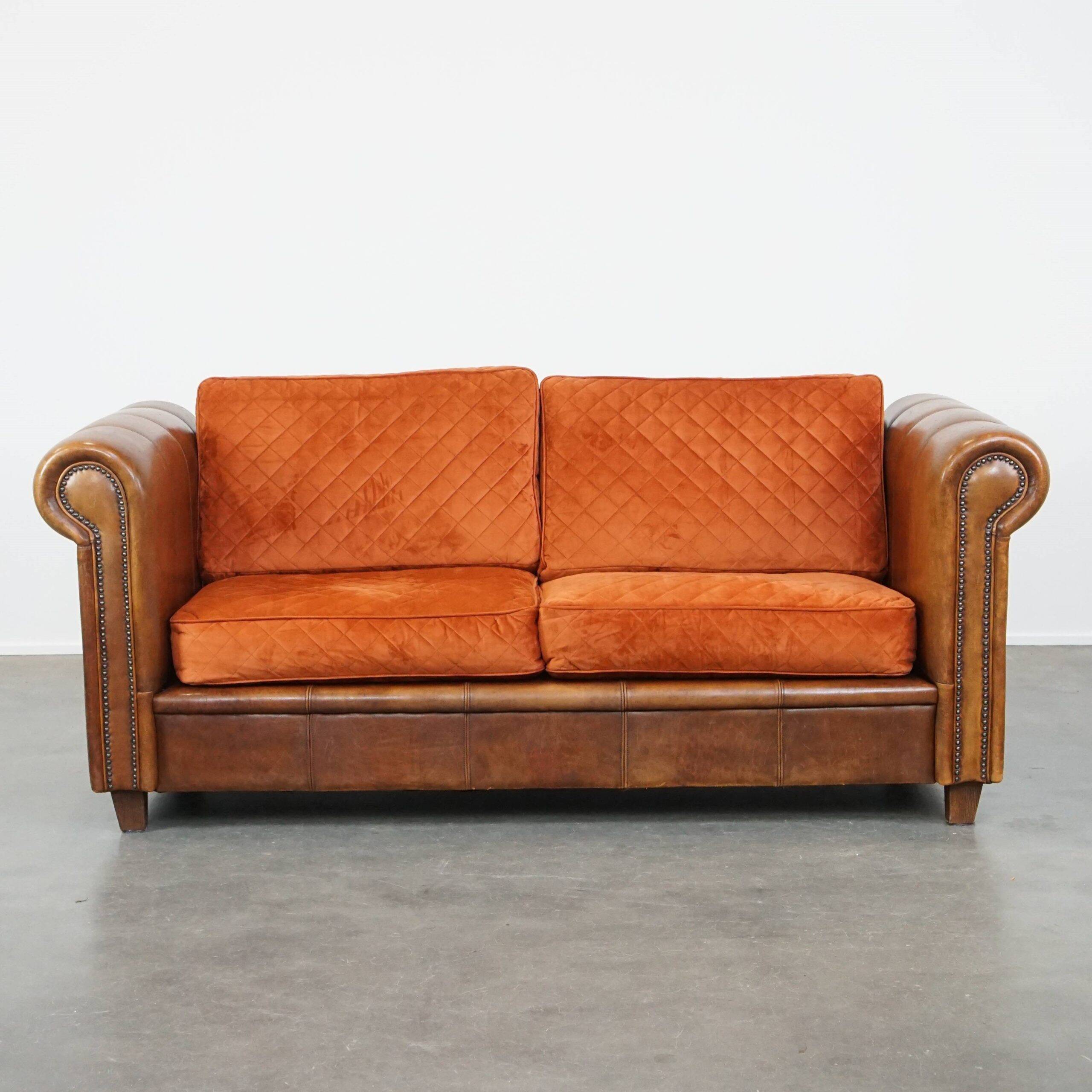 Luxury and comfortable sheepskin 2.5-seater sofa of top quality with orange fabric seat and back cushions