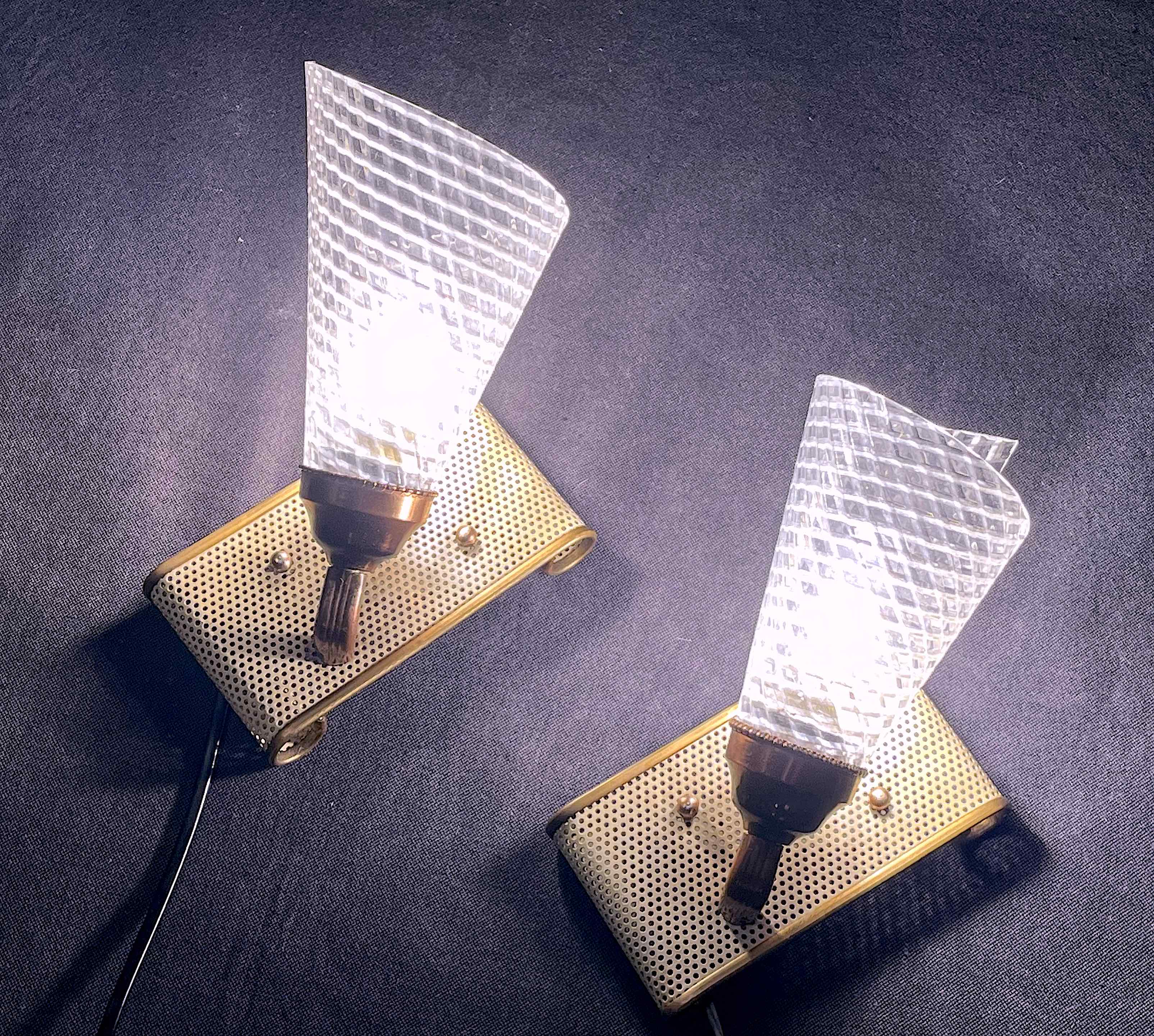Pair of brass sconces, perforated metal and perhapx conical lampshade, France 50's