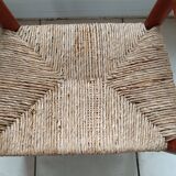 Children's wooden armchair and straw-covered seat.