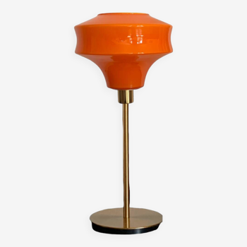 Table lamp with a vintage orange glass globe and a gold base