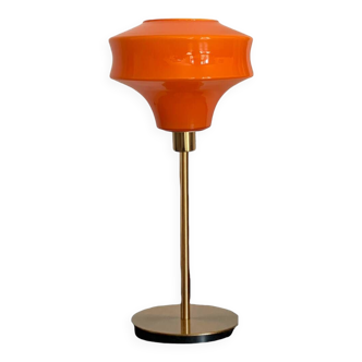 Table lamp with a vintage orange glass globe and a gold base