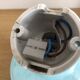 Wall light in ceramic with a light blue glass globe.