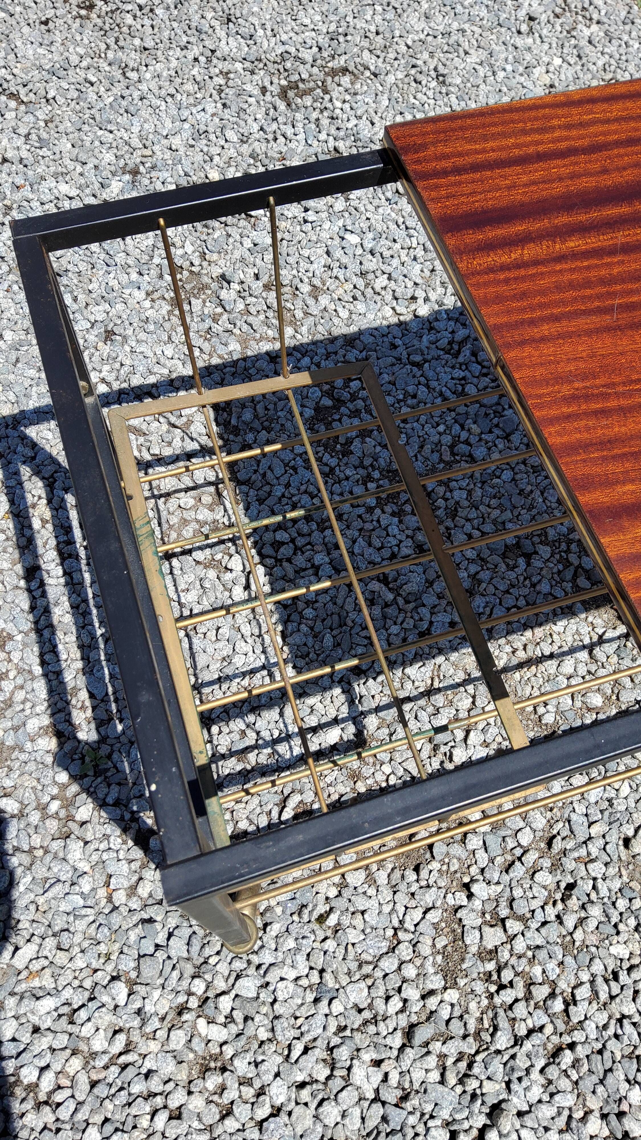 Coffee table from the 60s in black and gold metal tubes mahogany formica top