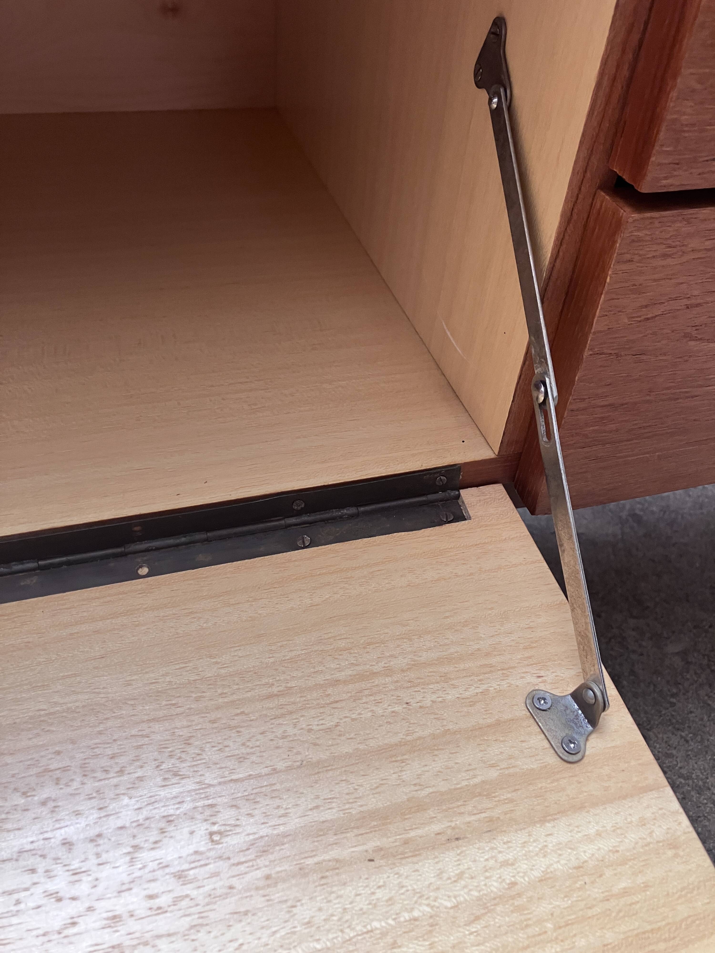 Teak sideboard with flap, 2 drawers and conical legs.