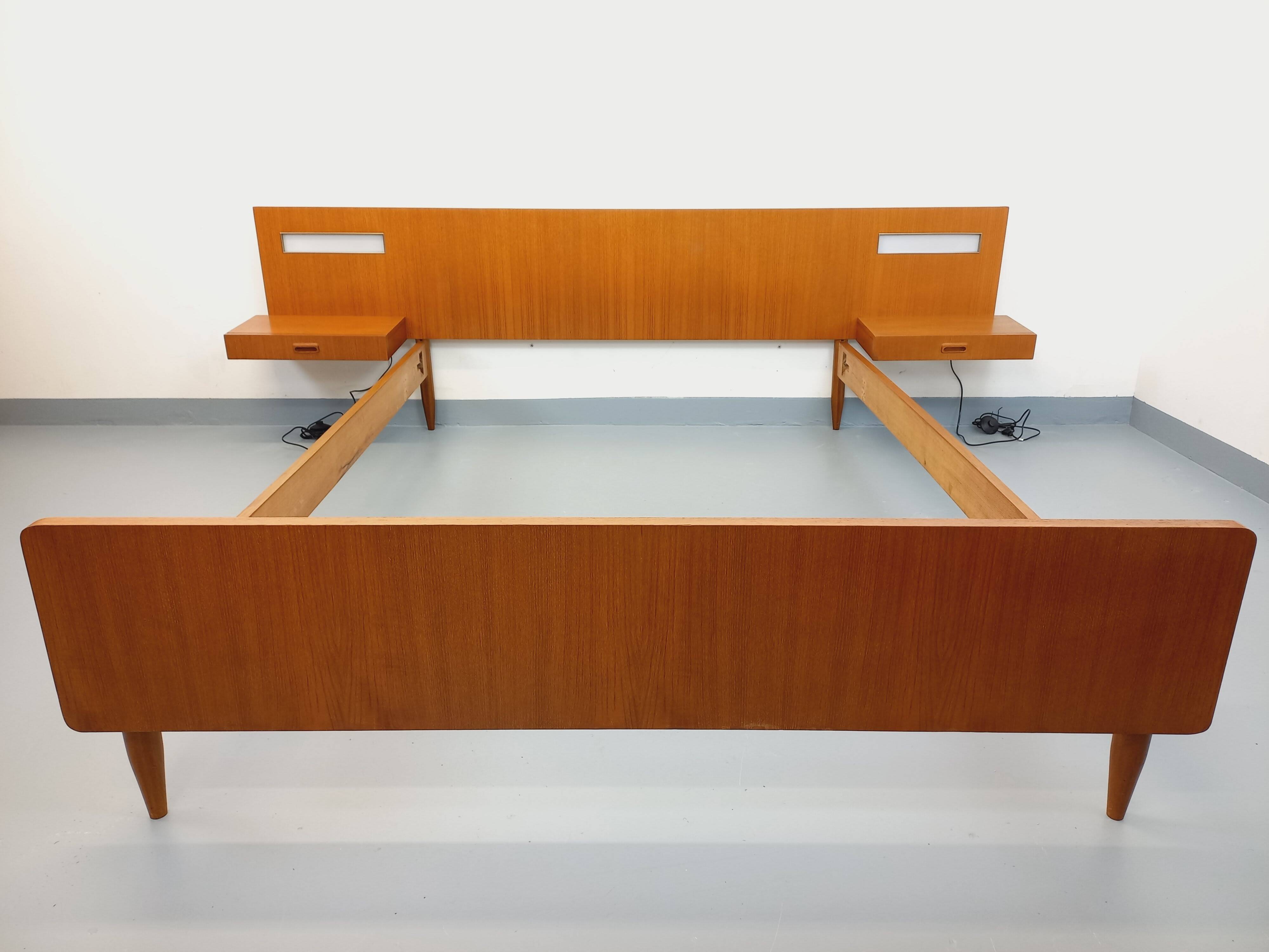 Double bed in vintage Scandinavian style from the 1960s with bedside tables.