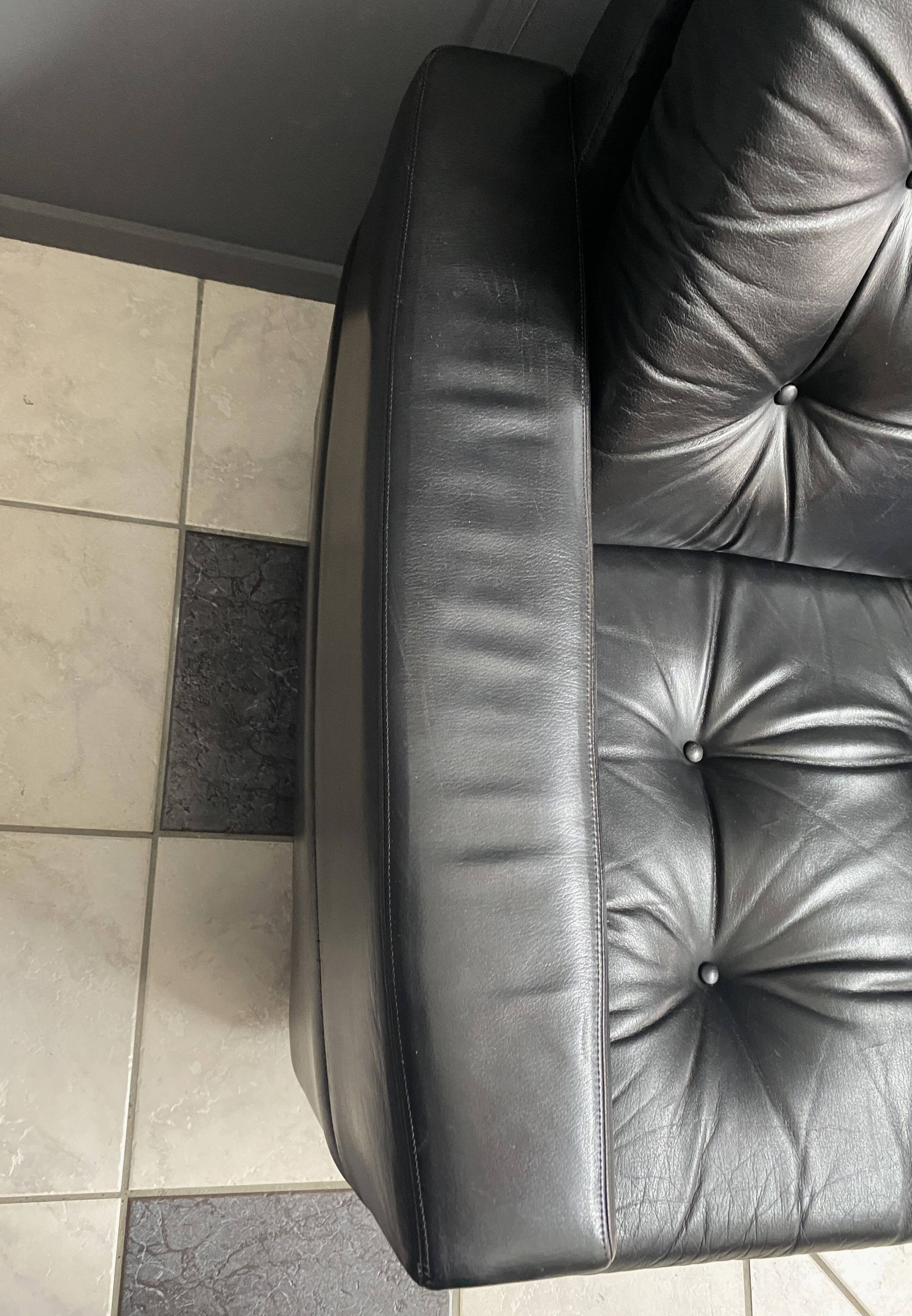 2 Black leather arm chairs 1960s on wheels